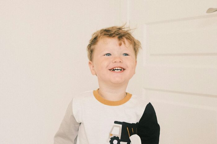 Smiling 4-year-old boy with messy hair indoors, representing out of control behavior after joining nursery. Smiling 4-year-old boy with messy hair indoors, representing out of control behavior after joining nursery.