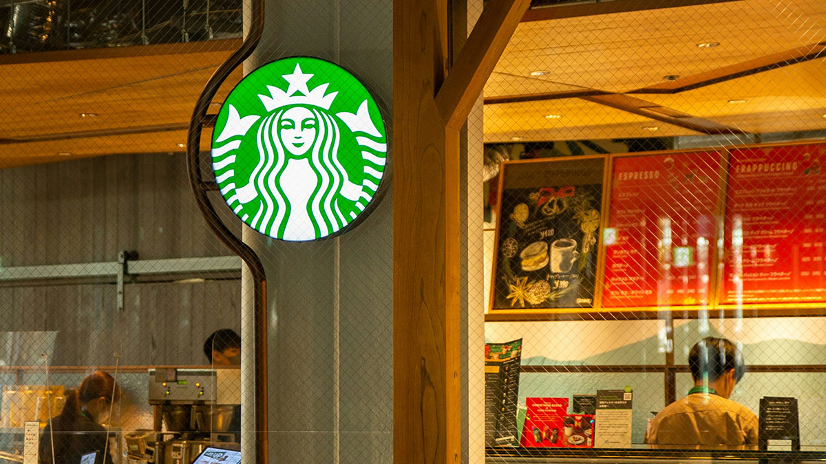 Starbucks store interior with employees preparing orders, illustrating unhinged company credit card uses.