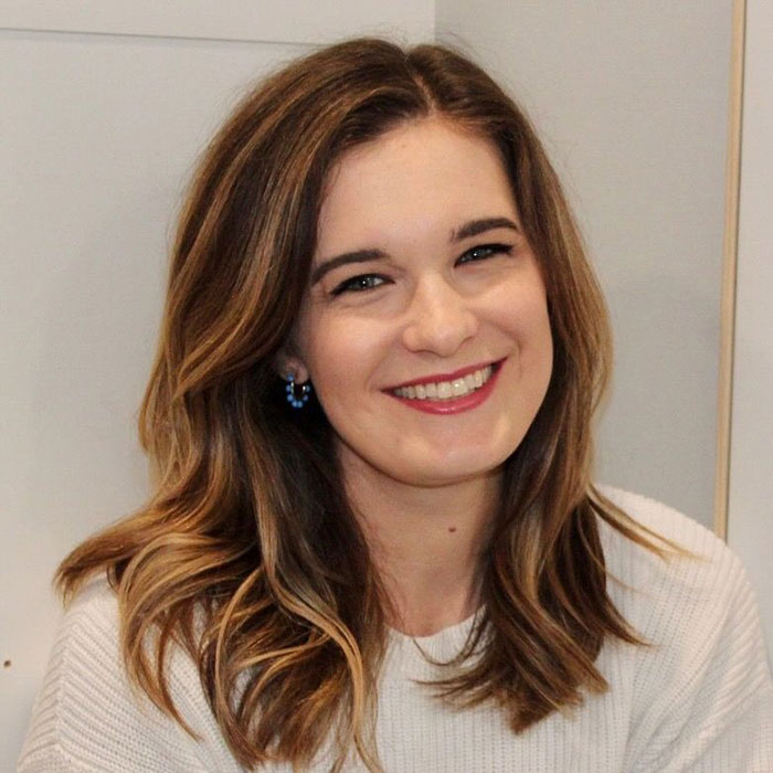 Smiling woman with light brown hair and blue earrings sharing viral story about mom telling 6YO daughter about Taylor Swift wedding. Smiling woman with light brown hair and blue earrings sharing viral story about mom telling 6YO daughter about Taylor Swift wedding.