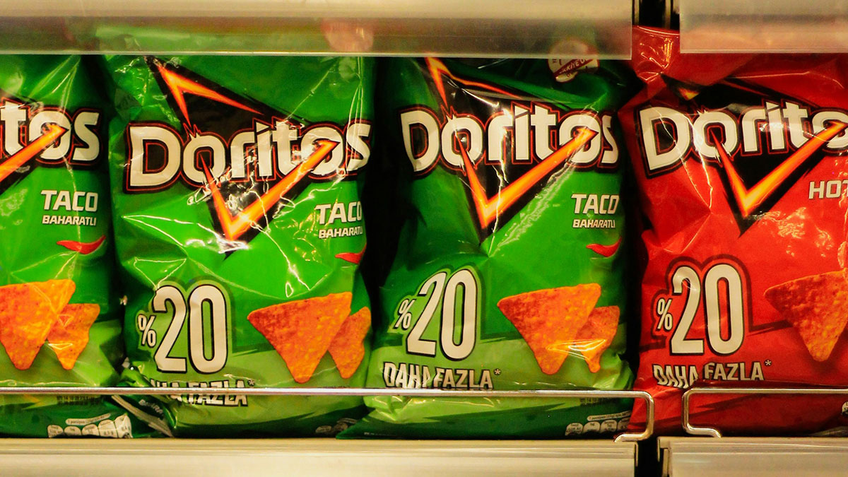 Bags of Doritos chips displayed on a store shelf representing common purchases ditched due to high price tags.