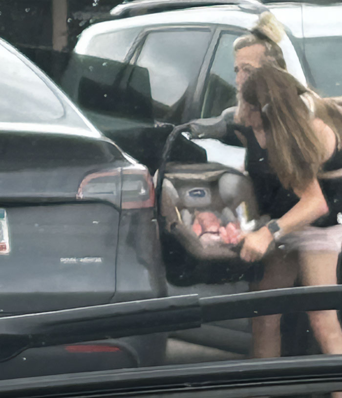 Two women with a baby in a car seat, highlighting after conjoined twins Abby and Brittany seen with a baby. Two women with a baby in a car seat, highlighting after conjoined twins Abby and Brittany seen with a baby.