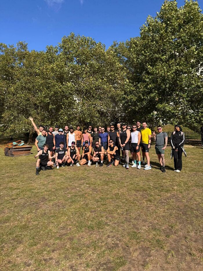 Group of runners posing outdoors on grass under clear sky, representing a gay running club gathering during a sunny day. Group of runners posing outdoors on grass under clear sky, representing a gay running club gathering during a sunny day.