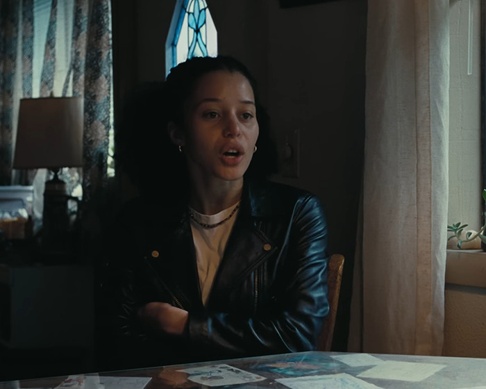 Chase Infiniti sitting at a table near a window, responding to a reporter's creepy question about Leonardo DiCaprio. Chase Infiniti sitting at a table near a window, responding to a reporter's creepy question about Leonardo DiCaprio.