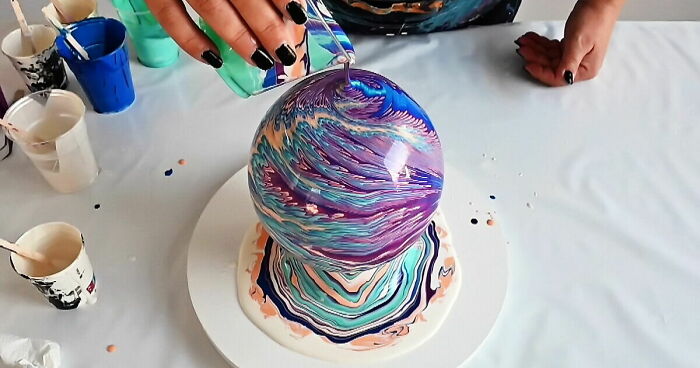 Person pouring colorful acrylic paint over a vase, demonstrating fun and easy acrylic pouring ideas for vase art.