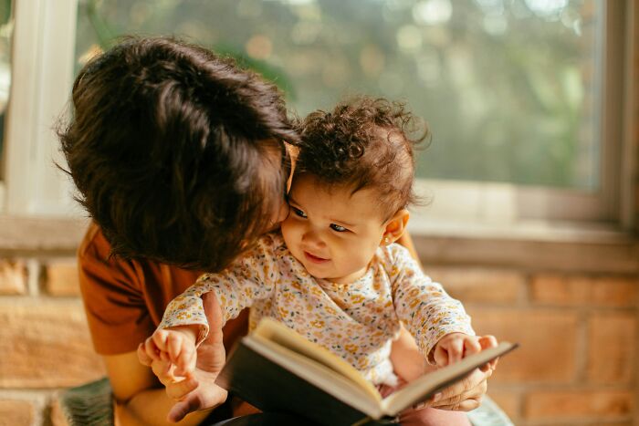 Parent reading a book with toddler, demonstrating creative parenting hacks to save sanity and improve daily routines.