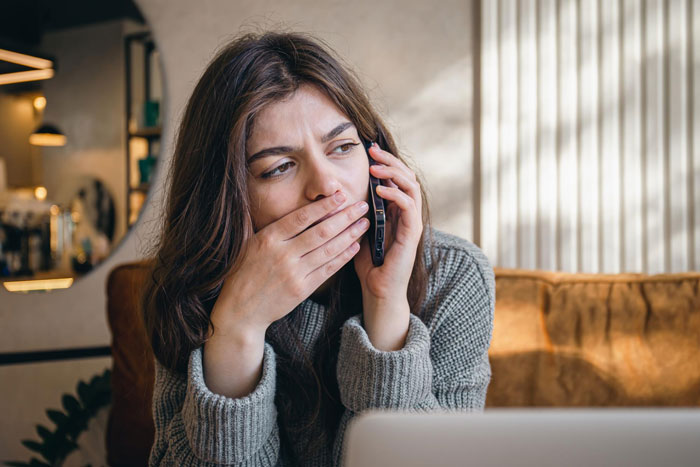 Young woman looking shocked while talking on phone, reacting to secret revealed about groom at bachelor party. Young woman looking shocked while talking on phone, reacting to secret revealed about groom at bachelor party.