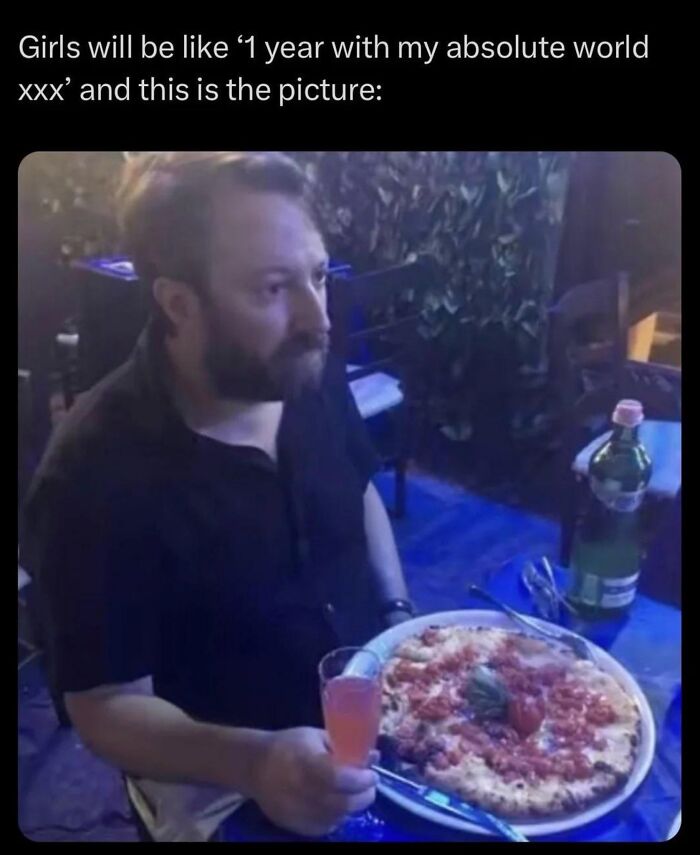 Man sitting at a table with pizza and a drink, illustrating men humor memes about coping instead of therapy.