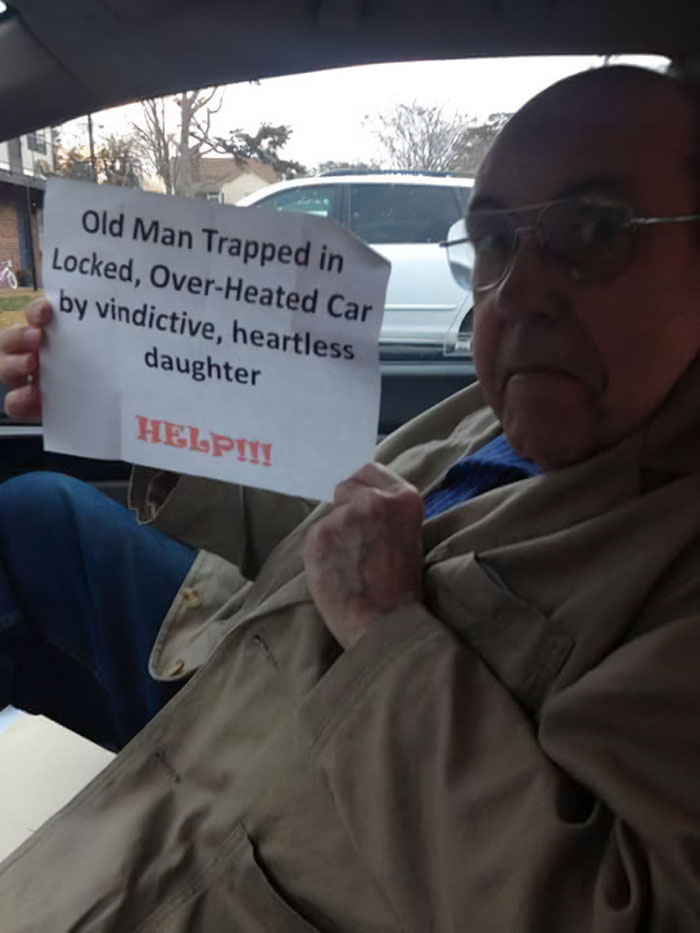 Elderly man holding a humorous sign about being trapped in a locked car, showcasing funny parents’ playful nature.