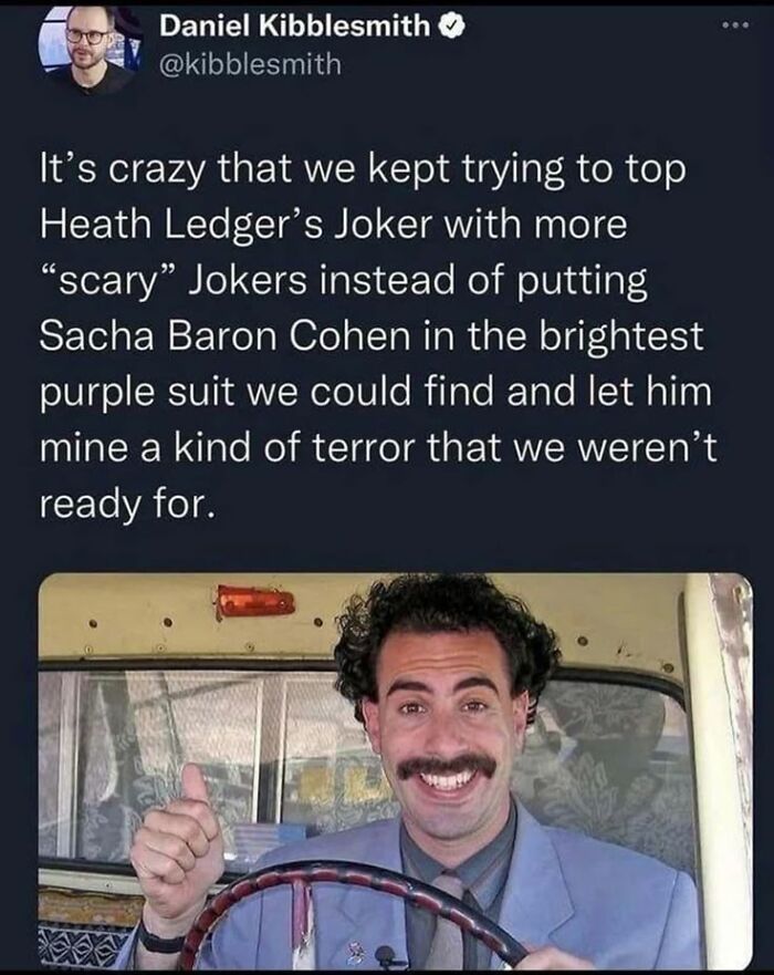 Tweet about Joker characters with image of Sacha Baron Cohen in bright purple suit, related to super culture entertaining posts and memes.