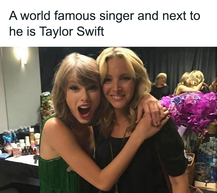 Two women hugging and smiling backstage with drinks and flowers around, a funny post from super culture memes.