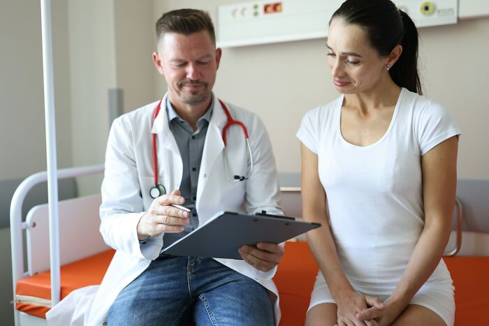 A doctor and a patient having a mind-boggling conversation in a medical office, discussing health concerns.