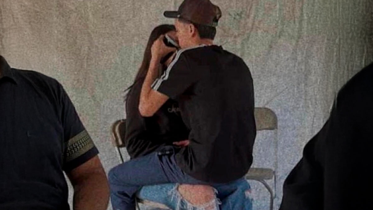 Two people sitting closely and hugging, depicting relatable moments about navigating the world as just a girl.