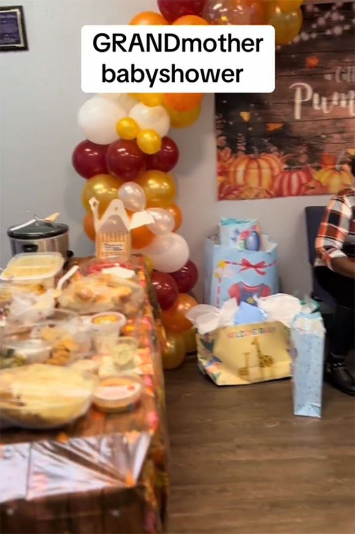 Baby shower decorations and gifts set up for a grandmother celebrating her new status with party food and balloons. Baby shower decorations and gifts set up for a grandmother celebrating her new status with party food and balloons.