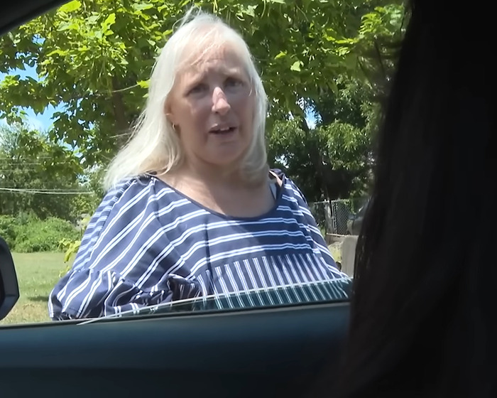 Woman with long blonde hair wearing a striped shirt outdoors, related to grandma arrested after 11-year-old girl's case. Woman with long blonde hair wearing a striped shirt outdoors, related to grandma arrested after 11-year-old girl's case.