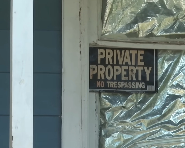 Private property sign posted on a door of a house linked to grandma arrested after 11YO girl allegedly gave birth case Private property sign posted on a door of a house linked to grandma arrested after 11YO girl allegedly gave birth case