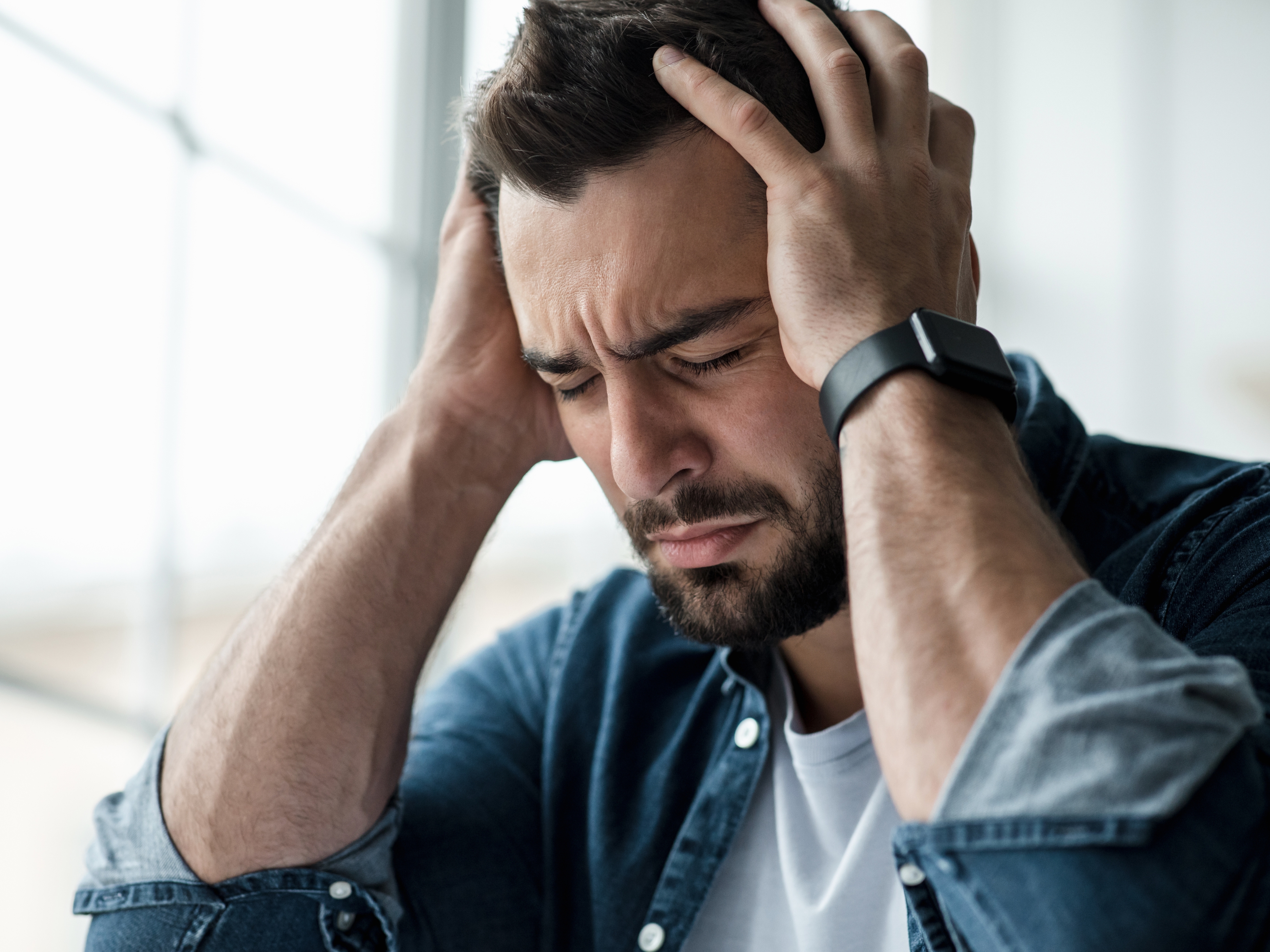Man stressed and holding his head, facing issues after woman moves out and ex demands house upgrade payments. Man stressed and holding his head, facing issues after woman moves out and ex demands house upgrade payments.