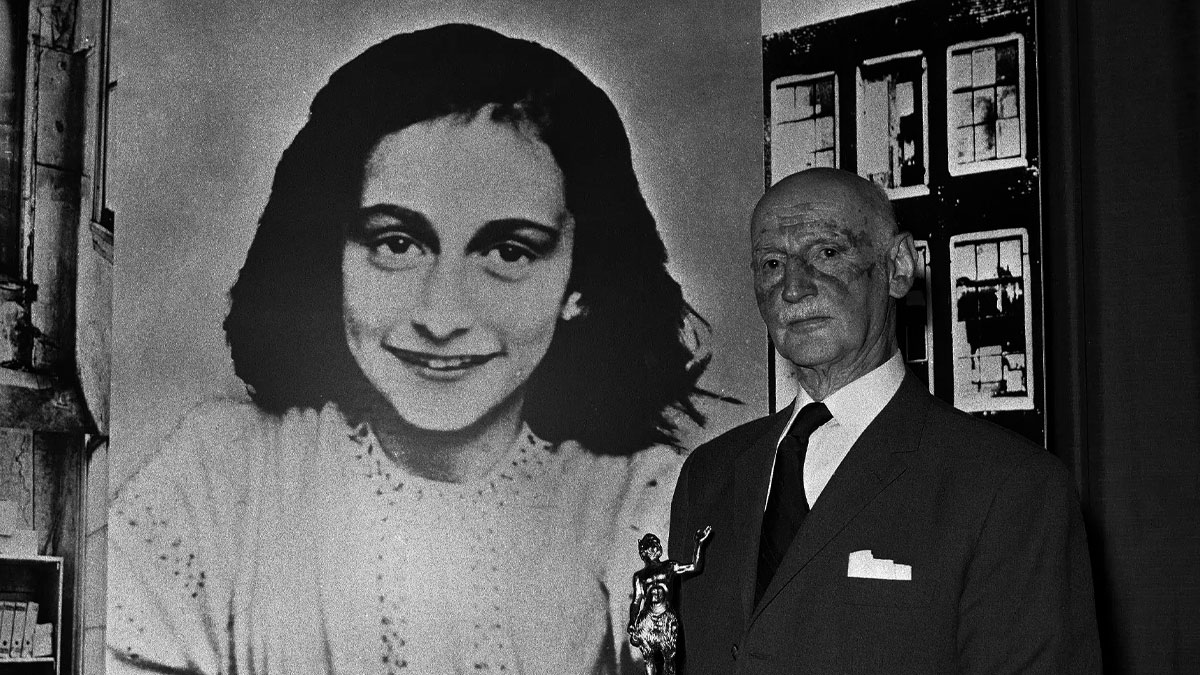 Black and white photo of an elderly man holding a statue standing next to a large portrait, perception of time concept