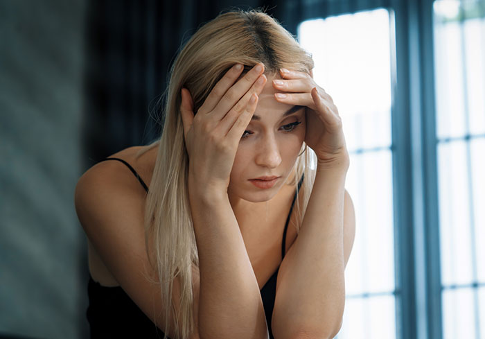 Stressed woman holding her head, feeling overwhelmed by husband expects wife work study full time and two kids demands. Stressed woman holding her head, feeling overwhelmed by husband expects wife work study full time and two kids demands.