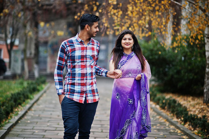 Couple holding hands walking outdoors in autumn, representing husband parents native language connection and culture. Couple holding hands walking outdoors in autumn, representing husband parents native language connection and culture.