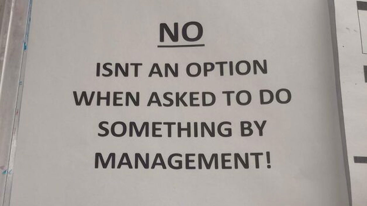 Printed sign stating no isn't an option when asked to do something by management, highlighting boss issues.