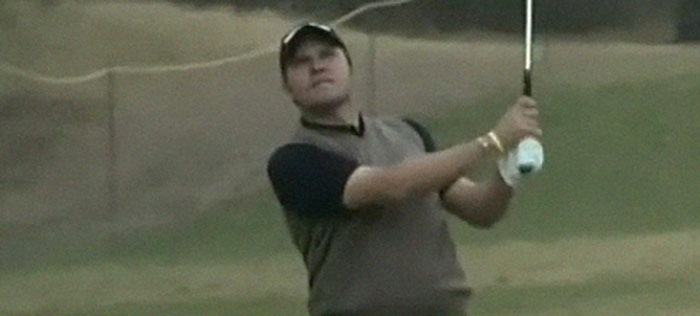 Man in casual golf attire swinging a club on a grassy course, illustrating facts for daily dose of fascinating knowledge.