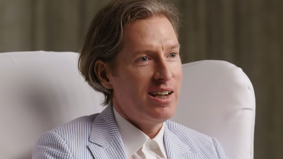 Man with light brown hair wearing a striped blazer and white shirt, sharing useless yet fascinating knowledge.