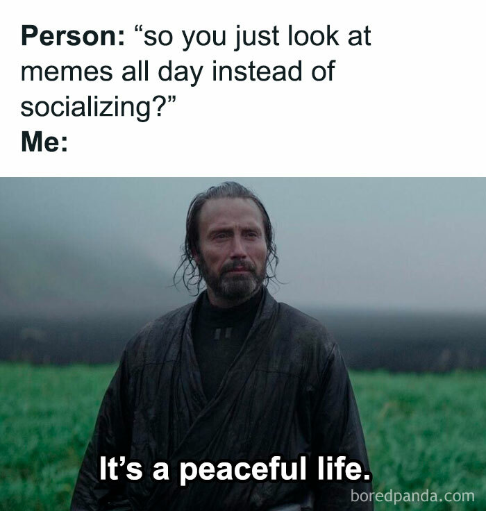 Man in dark robe standing outdoors in rain with text about introvert memes and a peaceful life after socializing.