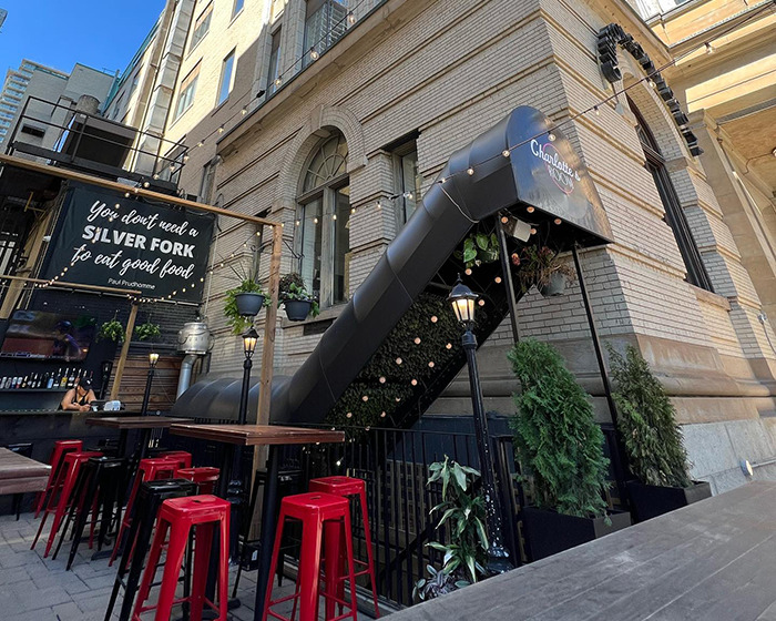 Outdoor bar area with red stools and plants, setting scene related to James McAvoy sucker punched incident. Outdoor bar area with red stools and plants, setting scene related to James McAvoy sucker punched incident.