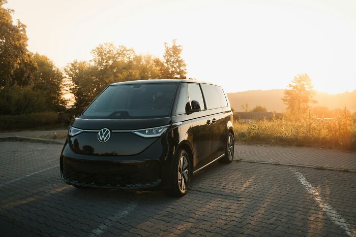 Black Volkswagen van parked outdoors at sunset, illustrating subtle ways misogyny can creep into daily lives.