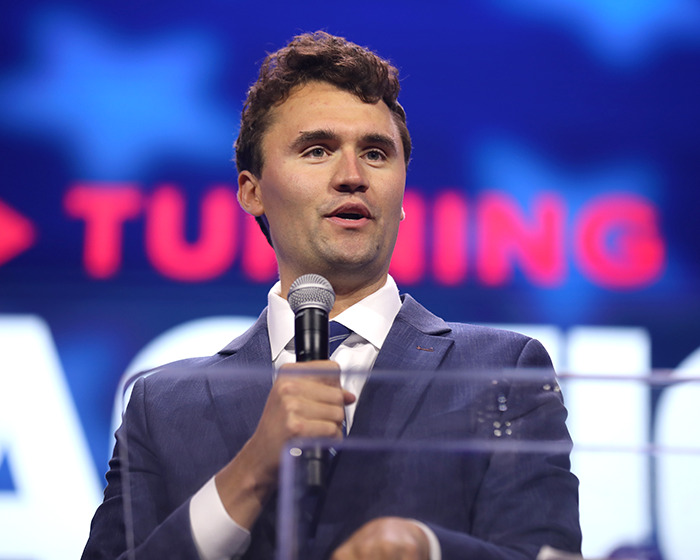 Man in a suit speaking into a microphone at a podium, related to Jimmy Kimmel suspension and Charlie Kirk comments. Man in a suit speaking into a microphone at a podium, related to Jimmy Kimmel suspension and Charlie Kirk comments.