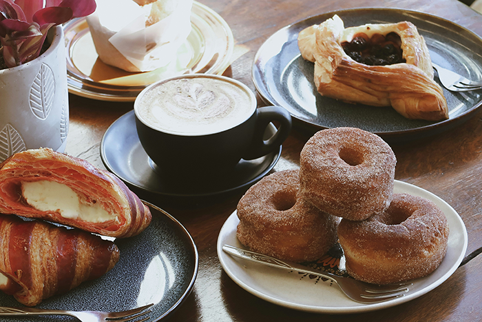 Coffee and assorted pastries on plates, representing a casual setting for a 23YO confronting married coworker fears. Coffee and assorted pastries on plates, representing a casual setting for a 23YO confronting married coworker fears.