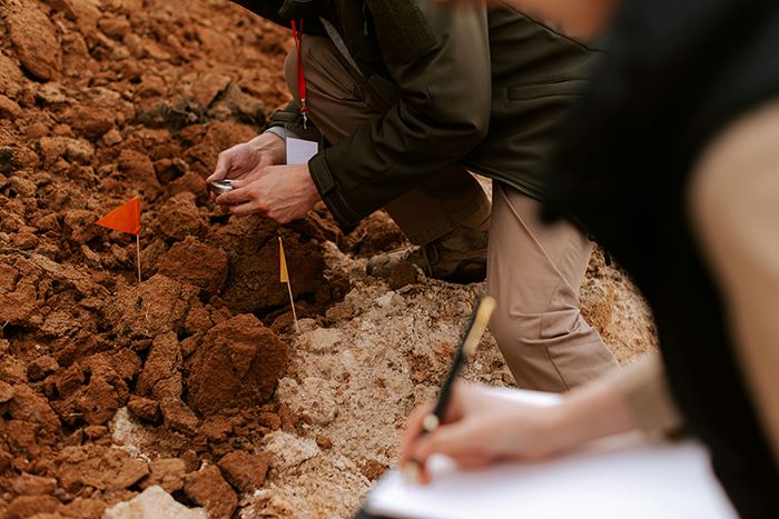 Archaeologists documenting and excavating ancient skeletons buried under an abandoned department store site. Archaeologists documenting and excavating ancient skeletons buried under an abandoned department store site.