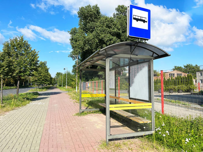 Bus stop shelter on a sunny day near a sidewalk with trees, ideal for kids waiting safely in parenting routines. Bus stop shelter on a sunny day near a sidewalk with trees, ideal for kids waiting safely in parenting routines.