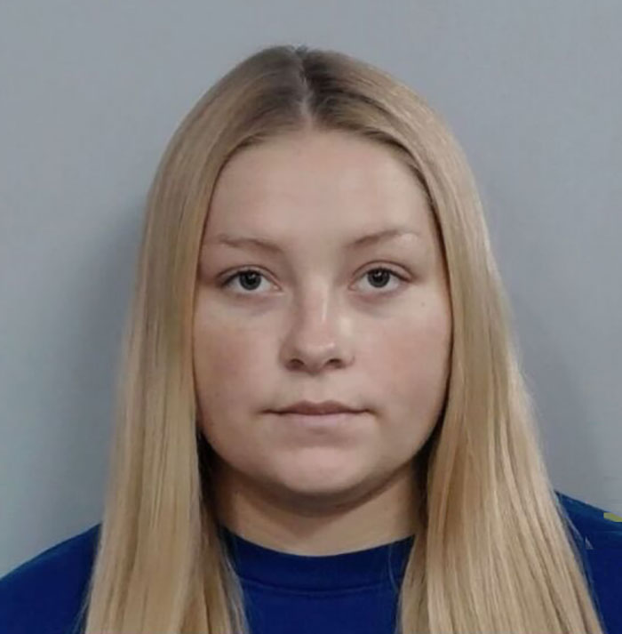 Young woman in a blue shirt, posing for a mugshot related to cheerleader arrested for hiding newborn body news. Young woman in a blue shirt, posing for a mugshot related to cheerleader arrested for hiding newborn body news.