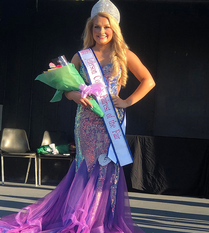 Cheerleader wearing crown and sash holding flowers, representing a university student involved in a newborn closet incident. Cheerleader wearing crown and sash holding flowers, representing a university student involved in a newborn closet incident.