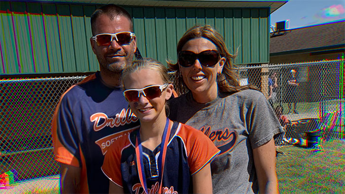 Family photo of a mom, daughter, and man outdoors, related to mom who anonymously sent daughter lewd texts for a year. Family photo of a mom, daughter, and man outdoors, related to mom who anonymously sent daughter lewd texts for a year.