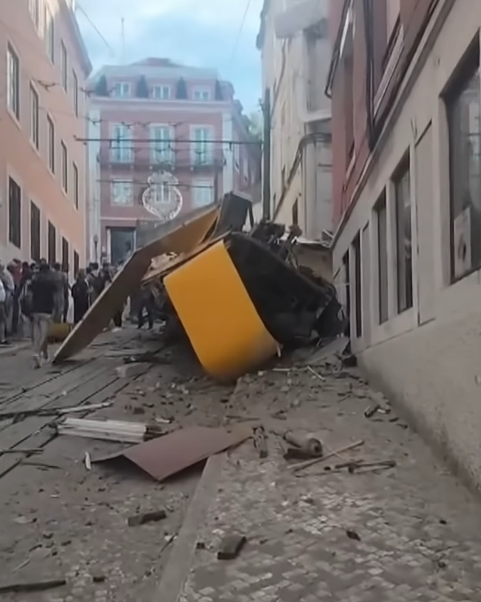 Wreckage from Lisbon crash scene with rescue efforts underway after toddler son saved and dad found alive. Wreckage from Lisbon crash scene with rescue efforts underway after toddler son saved and dad found alive.