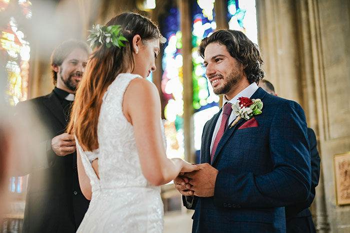 Bride and groom exchanging vows in a church setting, illustrating a robotically calculated choice for brains over heart. Bride and groom exchanging vows in a church setting, illustrating a robotically calculated choice for brains over heart.