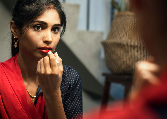 Woman applying lipstick, preparing to pretend as the bride at sister-in-law’s wedding despite family ties. Woman applying lipstick, preparing to pretend as the bride at sister-in-law’s wedding despite family ties.