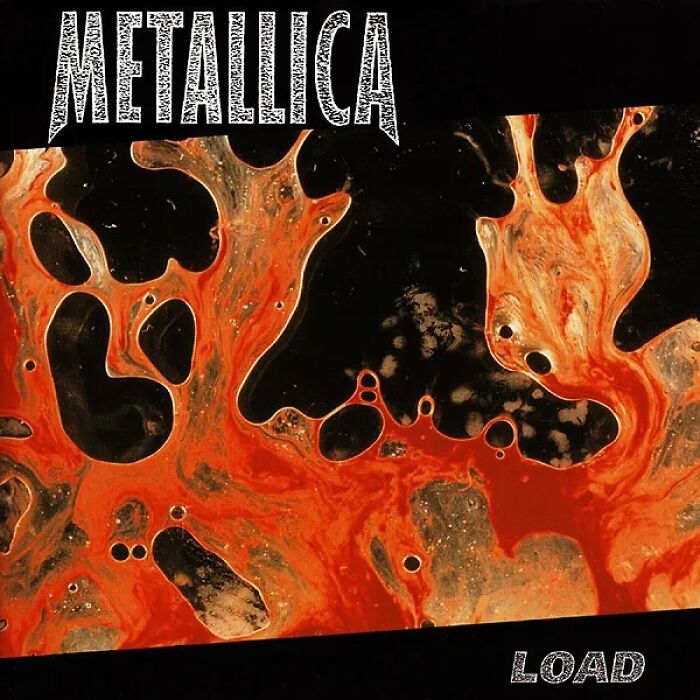 Abstract red and black album cover with Metallica band name and Load title, featured among worst album covers by fans.