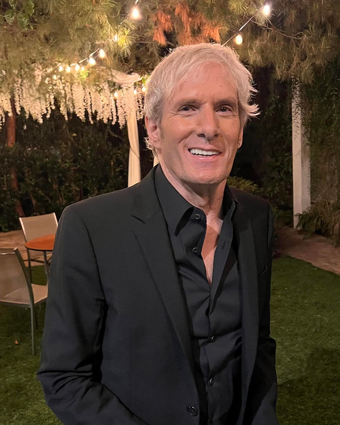 Michael Bolton smiling outdoors at night, wearing a black suit, highlighting a weird symptom before his heartbreaking diagnosis. Michael Bolton smiling outdoors at night, wearing a black suit, highlighting a weird symptom before his heartbreaking diagnosis.