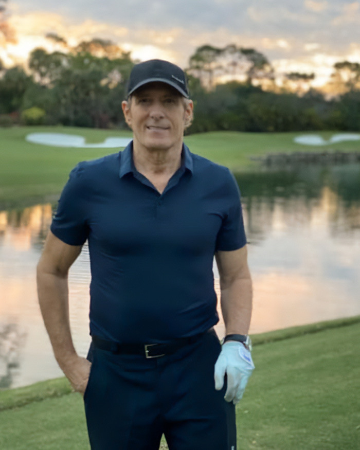 Man in golf attire standing by a lake at sunset showing weird symptom before doctors shared heartbreaking diagnosis. Man in golf attire standing by a lake at sunset showing weird symptom before doctors shared heartbreaking diagnosis.