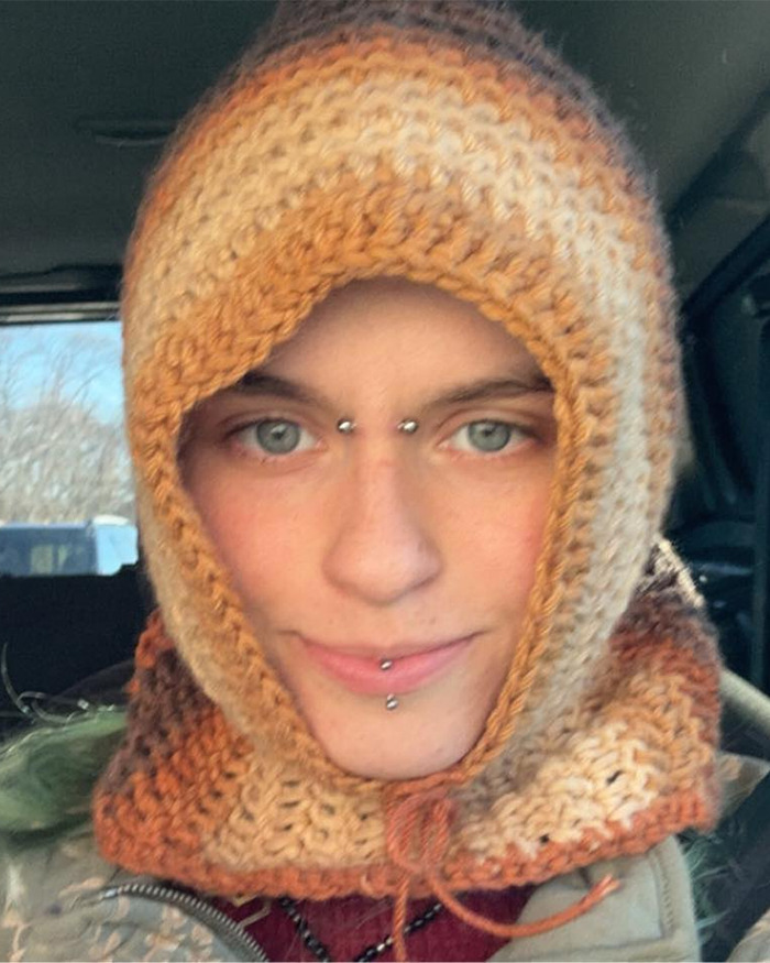 Close-up of Minneapolis suspect's furry girlfriend wearing a knitted hood with facial piercings inside a vehicle. Close-up of Minneapolis suspect's furry girlfriend wearing a knitted hood with facial piercings inside a vehicle.