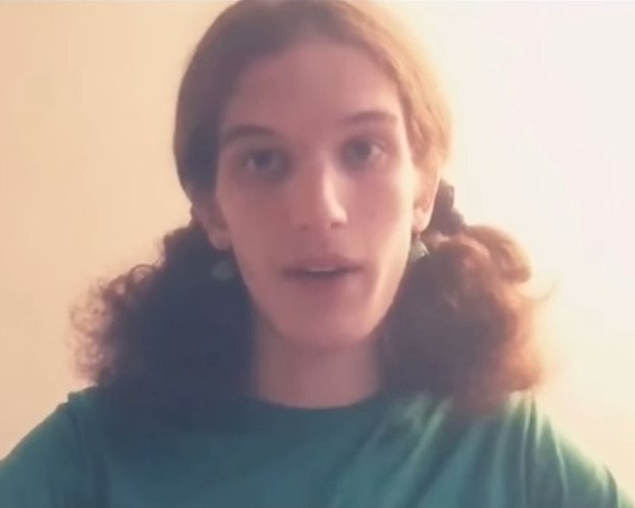 Young woman with curly hair in a green shirt, linked to Minneapolis suspect's furry girlfriend and disturbing journal entries. Young woman with curly hair in a green shirt, linked to Minneapolis suspect's furry girlfriend and disturbing journal entries.