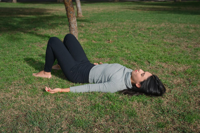 Teen lying on grass outdoors appearing in pain after fall, highlighting teen fainting and injury concerns.