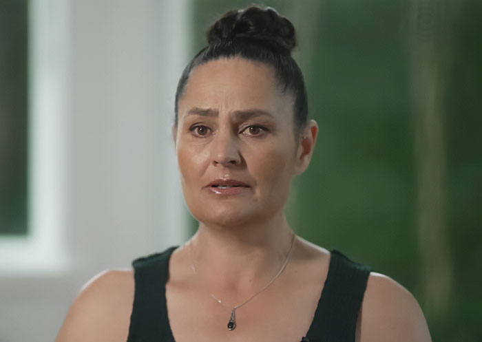 Mom of kids who vanished into wilderness speaking emotionally in an indoor setting with blurred green background. Mom of kids who vanished into wilderness speaking emotionally in an indoor setting with blurred green background.