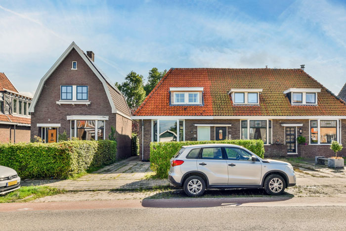 Silver SUV parked in front of a house with neighbor upset over nanny parking in front of home. Silver SUV parked in front of a house with neighbor upset over nanny parking in front of home.