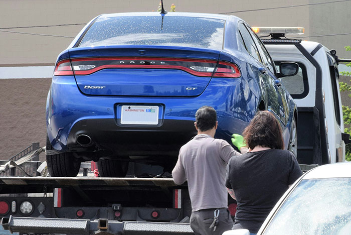 Blue Dodge Dart being towed as nurse confronts neighbor for repeatedly using her driveway after long shift. Blue Dodge Dart being towed as nurse confronts neighbor for repeatedly using her driveway after long shift.