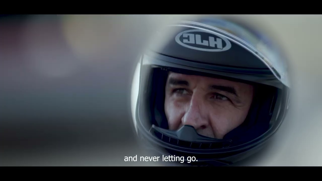 Close-up of a man wearing a motorcycle helmet, focused and ready to ride an Indian Motorcycle scene.