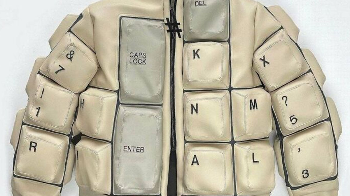 Padded jacket designed like keyboard keys with letters and symbols, showcasing a nonsensical fashion concept.